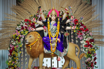 Goddess Durga with lion statue, Hindu goddess Durga idol, Navratri festival Durga maa, Divine Durga mata sculpture stock photo.