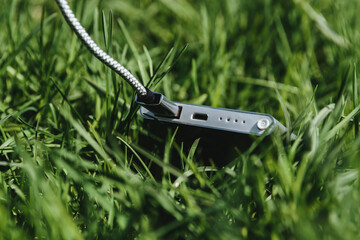 Compact Power Bank Charging Outdoors in Grass During Travel or Adventure