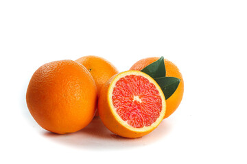 Fresh Blood Oranges with Red Flesh and Green Leaves on White Background