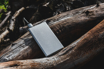Powering Up in Nature: Portable Charger on Natural Background