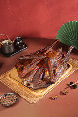 Chinese Roasted Whole Duck with Five Spice on Bamboo Platter Traditional Asian Cuisine