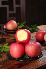Fresh Red Apples with Heart-Shaped Core Cut Section on Rustic Wooden Table