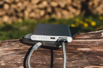 Close-up of a modern smartphone charging with a power bank.