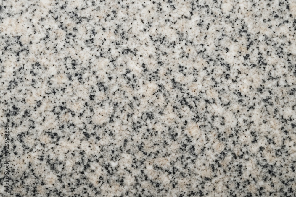 Poster closeup texture of light granite stone with speckled black and beige pattern, ideal for abstract bac