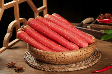 Fresh Red Carrots in Bamboo Basket - Sichuan Style Asian Cooking Ingredients on Rustic Wooden Kitchen Table