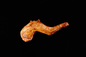 Roasted Rabbit Leg Sichuan Style with Sesame Seeds Chinese Cuisine on Black Background