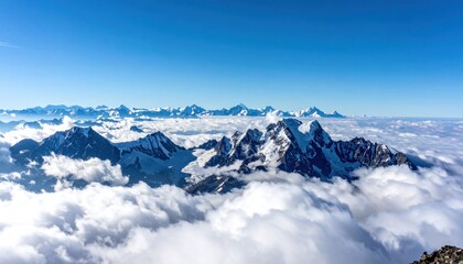 Snow-capped mountain peaks pierce fluffy clouds under a clear, bright blue sky, creating a stunning, high-altitude panorama
