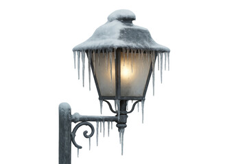 Street lamppost illuminating winter night with icicles