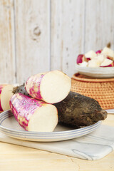 Fresh Purple Sweet Potatoes and Yam on White Plate Rustic Kitchen Still Life