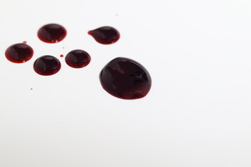 Droplets of blood spots on a white background. Side view