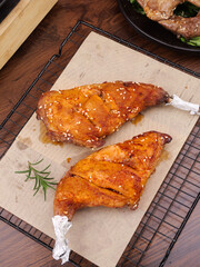 Szechuan Style Roasted Rabbit Legs with Fresh Herbs and Sesame Seeds on Cooling Rack