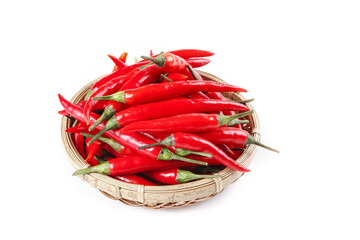 Freshly picked red chili peppers in wicker basket isolated on white background