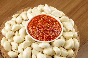 Fresh Garlic Cloves with Korean Chili Sauce in Bowl for Rice Seasoning and Asian Cooking