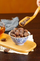 Chinese Herbal Medicine Nuts in Bowl with Tea for Natural Health and Throat Care