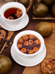 Herbal fruit tea with natural ingredients on wooden table - healthy wellness drink