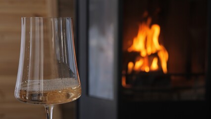 White wine pouring near fireplace creates a cozy mood glowing reflections emphasize coziness and warmth Scene of intimate relaxation where coziness defines luxury harmony and timeless celebration