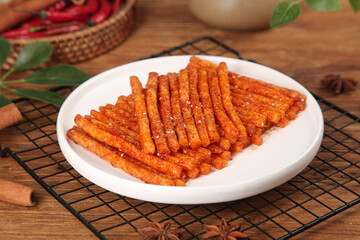 Spicy Beef Tendon Sticks Chinese Snack Food on Wooden Background