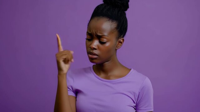 Young african woman showing surprise in a purple t-shirt against a matching background, A young african woman in a t-shirt showing oops gesture and wrinkling forehead in a purple studio