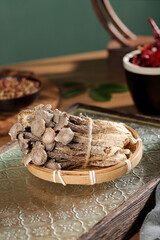 Traditional Dried Medicinal Herbs and Roots in Bamboo Basket - Natural Health Ingredients