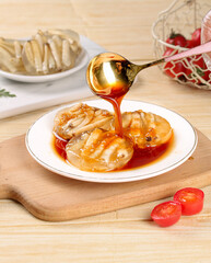 Traditional Chinese Xiamen Specialty Jelly Dessert with Sweet Syrup and Dumplings on Wooden Board
