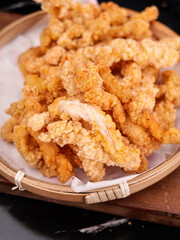 Crispy Fried Pork Rinds in Bamboo Basket - Traditional Street Food Snack