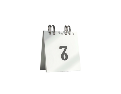 A small, white desk calendar displaying the number seven, bound with silver rings, angled slightly towards the viewer, set against a black background