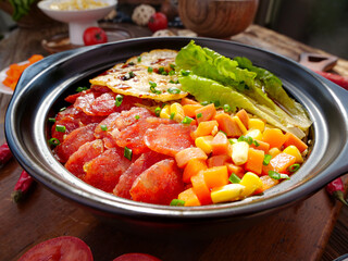 Special Northeastern Chinese Waxed Meat Rice Casserole with Vegetables in Traditional Ceramic Pot
