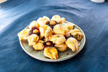 Puff pastry flower with raspberry jam filling. Baked goods. Desserts. Food concept.