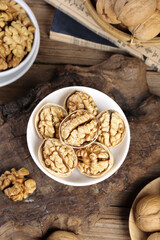 Large delicious Xinjiang walnuts in bowl on wooden table - healthy nuts food photography