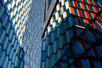 Glass façade detail with colored panels, modern architecture showing clarity, geometry and minimalist composition, background copy space ideal for design, posters and templates