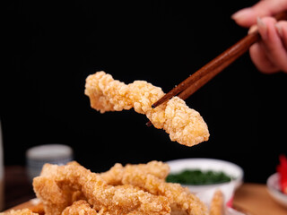 Crispy Fried Chicken with Chopsticks - Golden Asian Style Comfort Food on Black Background