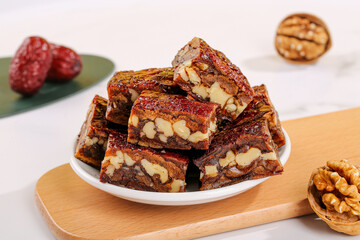 Xinjiang Walnut Jujube Date Pie Squares - Traditional Chinese Pastry with Nuts and Red Dates on Wooden Board