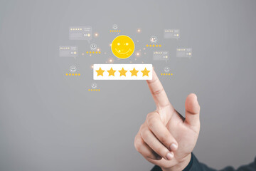 Hand pointing at five star rating with smiling face icon, concept of excellent customer...
