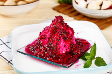 Purple Yam Dessert with Berry Sauce and Fresh Mint Garnish on White Plate