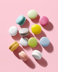 Fototapeta premium pastel-colored macarons flat lay on pink background, playful minimal food, copyspace