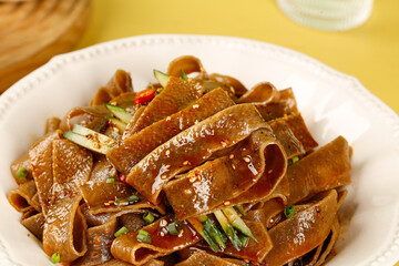 Buckwheat Noodles with Savory Sauce and Fresh Garnishes on White Plate