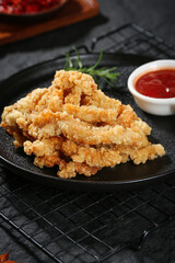 Crispy Fried Chicken Strips with Spicy Sauce on Black Slate Plate