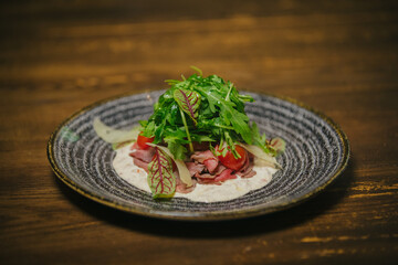 Gourmet roast beef salad with fresh arugula and tomatoes