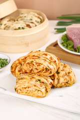 Traditional Chinese Scallion Pancakes with Steamed Pork Buns and Fresh Ingredients Asian Breakfast Setup