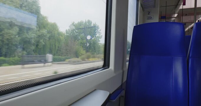 The Hague, Netherlands, August 26, 2025. Empty seats inside Dutch train heading for The Hague. Wide angle view, blue upholstery, real time, no people
