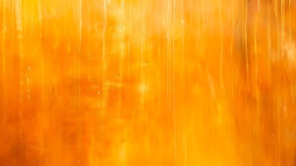 Abstract warm orange background with vertical streaks and soft glowing light effect for creative projects and designs