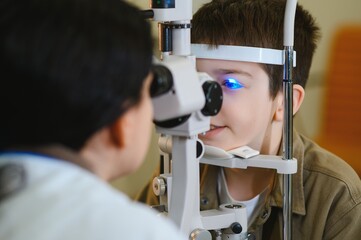 Ophthalmologist performing vision diagnostics on child with medical equipment