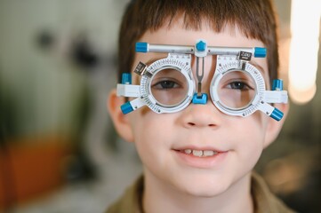 Child undergoing vision diagnostics with phoropter during ophthalmological examination