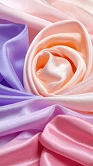 Soft, flowing silk fabrics in a gradient of pastel colors