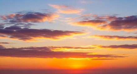 Dramatic sunset sky with vibrant colors and soft cloud formations horizon