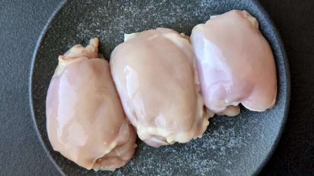Raw chicken thigh fillet, poultry meat as a source of protein. Chicken thigh fillet as a food background for your design.