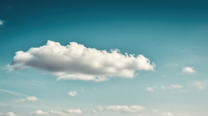Fluffy white cloud against blue sky, minimalist nature composition with ample negative space and soft daylight. travel magazines.