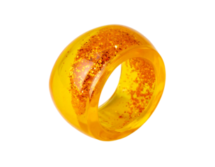 Translucent amber-yellow ring encasing flecks of darker orange glitter, creating a vibrant, sparkly effect.  The ring is thick and wide, with a smooth, polished surface