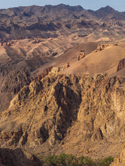 Breathtaking Kazakh canyon with fiery rock layers and dramatic erosion-carved contours.