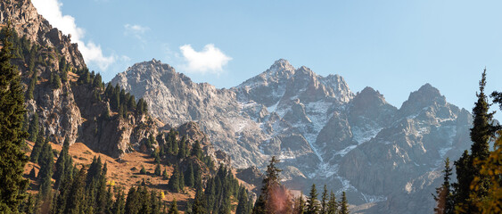 Untouched Kazakh wilderness showcasing mountain grandeur and pastoral valley beauty.